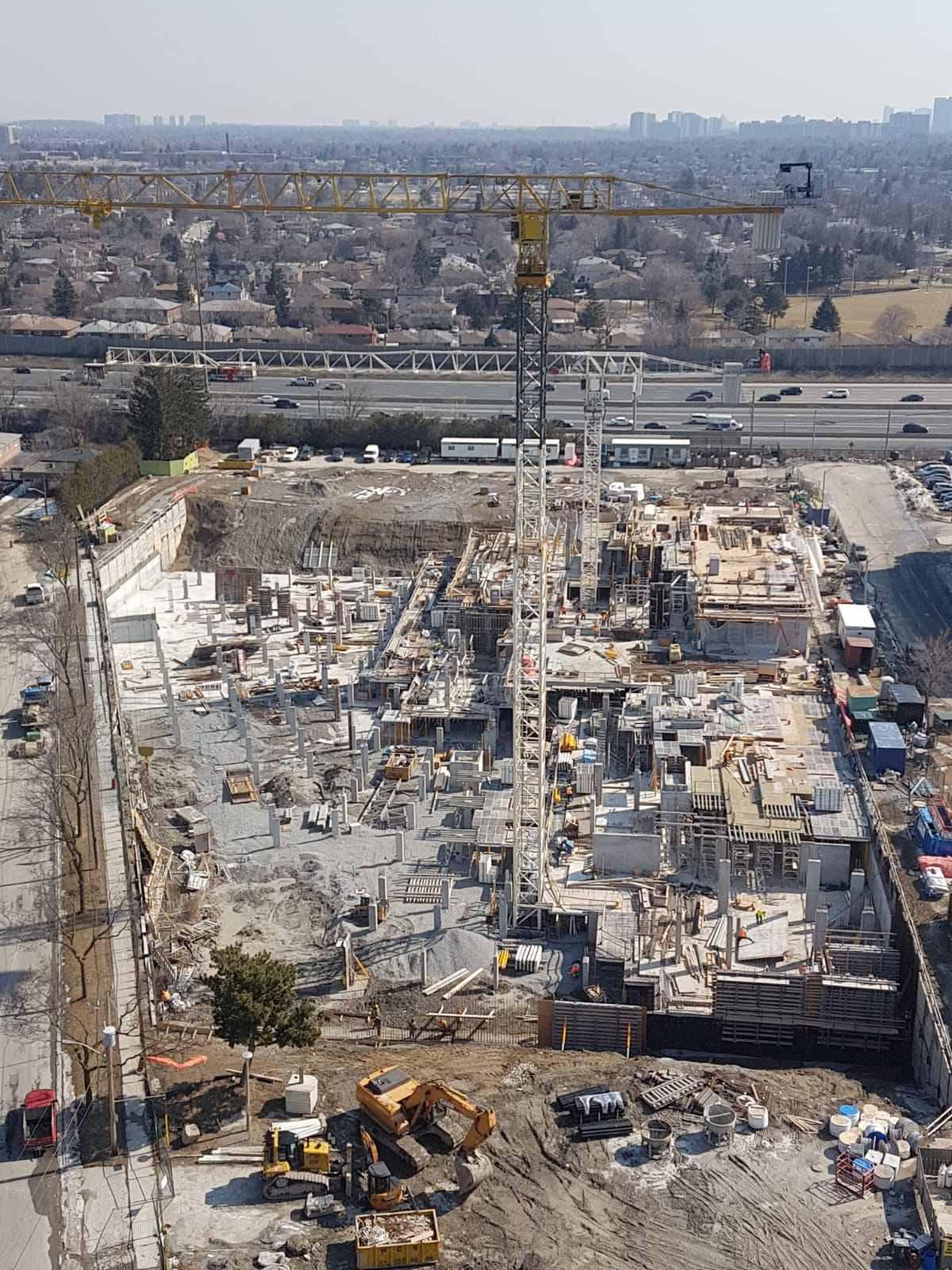 High-angle view of a major construction site showing foundation work and active layout coordination